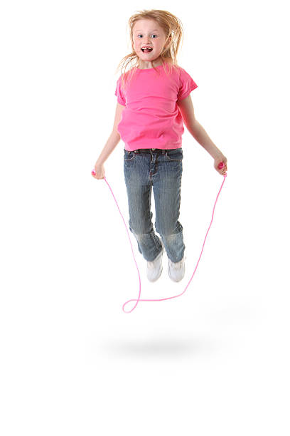 young girl jumping rope stock photo