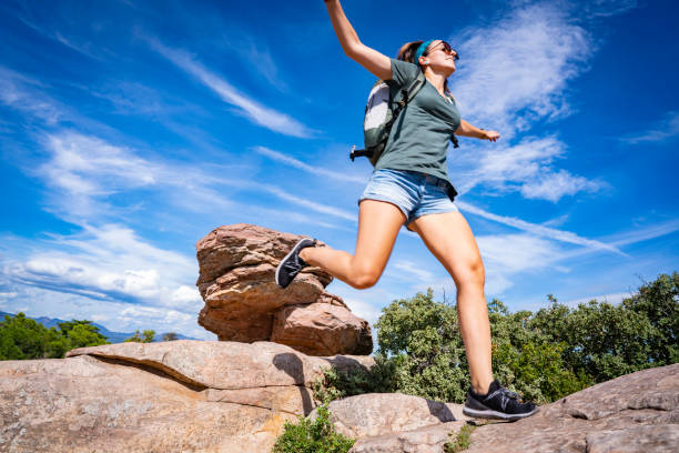 ung flicka hoppar trekking i mountain peak - energetic jumping bokeh bildbanksfoton och bilder