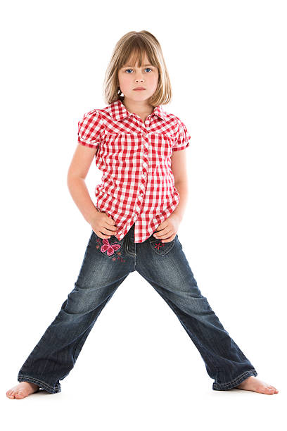 Young girl looking moody with hands on hips stock photo