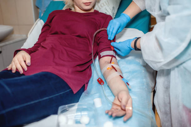 Young girl on hemodialysis in hospital, dialysis system equipment, kidney disease chronic patient stock photo