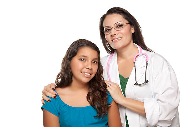 Young girl portrait with a female doctor Pretty Hispanic Girl and Female Doctor Isolated on a White Background. mexican teenage girls stock pictures, royalty-free photos & images