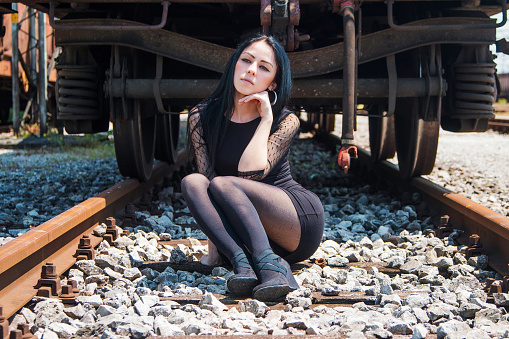 Beautiful girl sitting on rails — Stock Photo © Zoreslava 