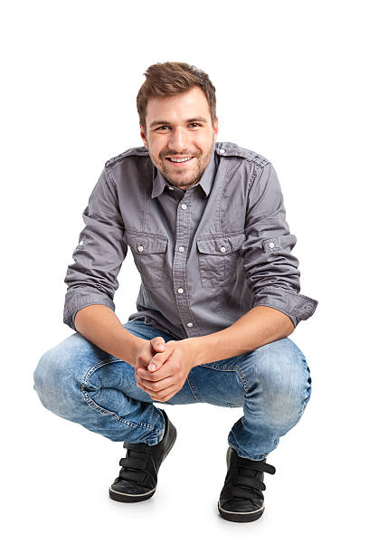 young handsome man crouching stock photo