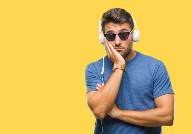 young-handsome-man-wearing-headphones-listening-to-music-over-picture