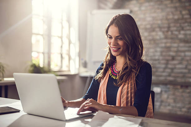young-happy-businesswoman-working-on-lap
