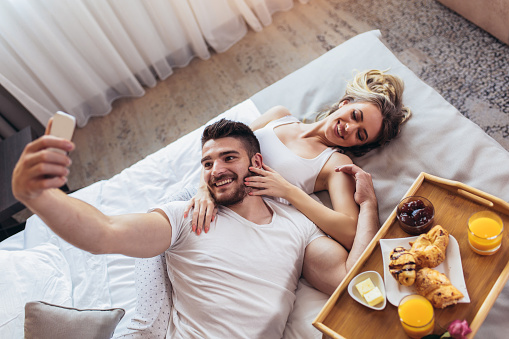Young Happy Couple Having Breakfast In Luxury Hotel Room Stock Photo - Download Image Now - iStock