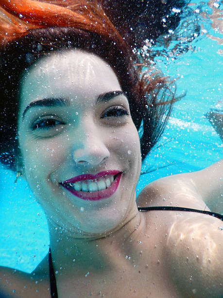 Сaucasian Pregnant Woman Underwater In Blue Sea Closeup 