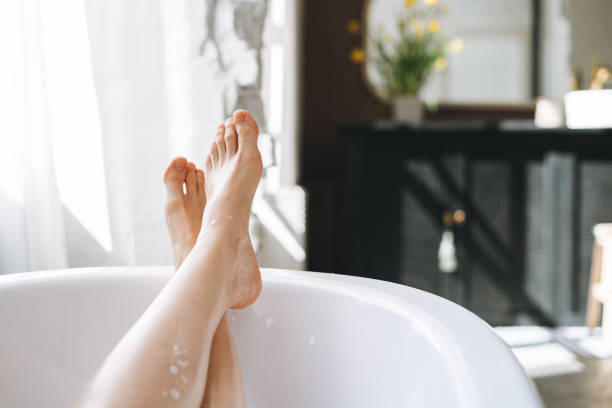 Young happy woman taking bath at home, treat yourself stock photo