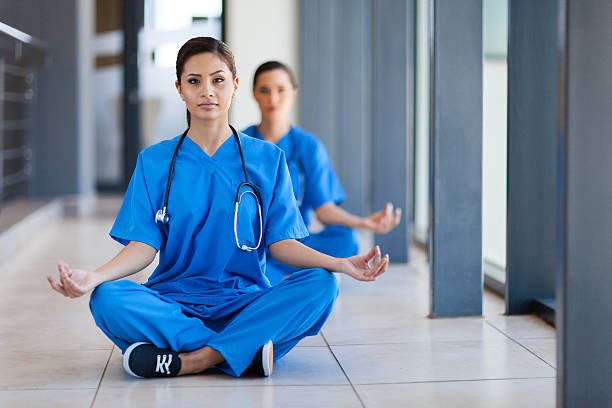 young healthcare workers meditation during break stock photo