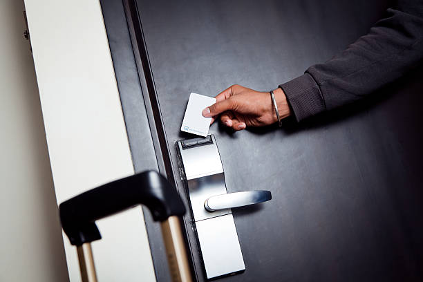 young indian man unlocking his hotel room stock photo