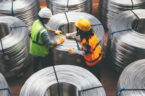 young industry employees checking production line in wire warehouse - fibra imagens e fotografias de stock