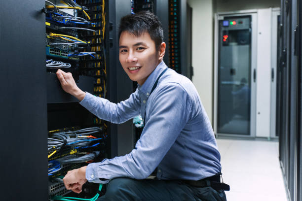 Young IT engineer near data center servers stock photo