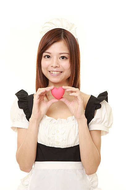 young Japanese woman wearing french maid costume with heart portrait of young Japanese woman wearing french maid costume french maid outfit stock pictures, royalty-free photos & images