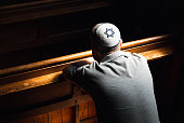 istock Young Jewish man wearing skull cap praying inside synagogue 1323656071