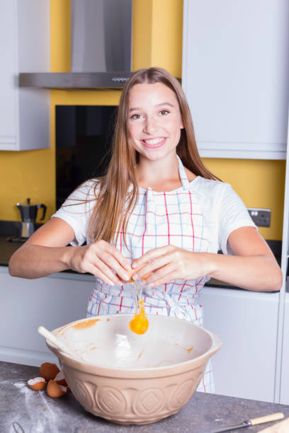 Young lady preparing ingredients in the kitchen stock photo
