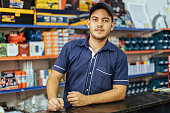 istock Young latin man working in hardware store 1353444509