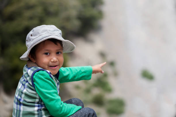 Young latino boy in awe after spotting elusive wildlife in Southern California mountains. stock photo