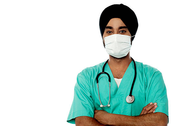 Young male doctor with face mask stock photo