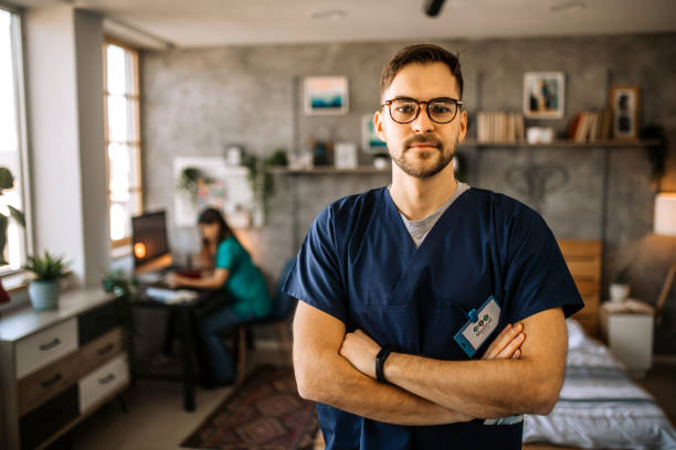 Young male nurse home caregiver stock photo