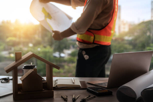 Young Man Architect Or Engineer Working At Desk With