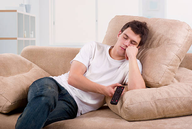 young-man-asleep-in-front-of-tv-picture-id120104278