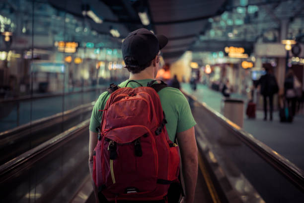 Young man at airport going on vacation. stock photo