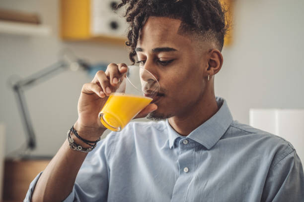 Young man at home Young man at home juice drink stock pictures, royalty-free photos & images