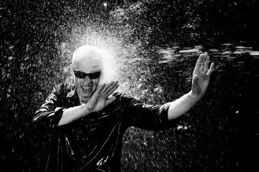 Young Man Being Sprayed With Water Black And White Stock Photo ...