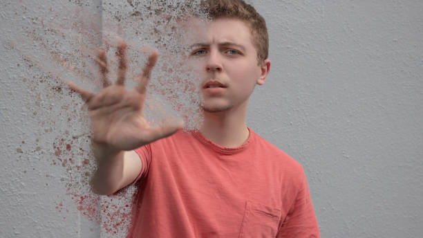 A young man dematerializes stock photo