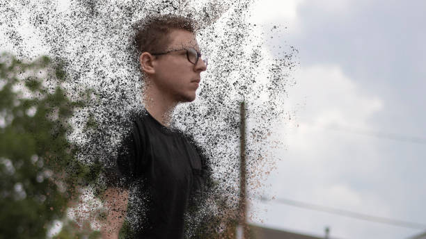 A young man dematerializes stock photo