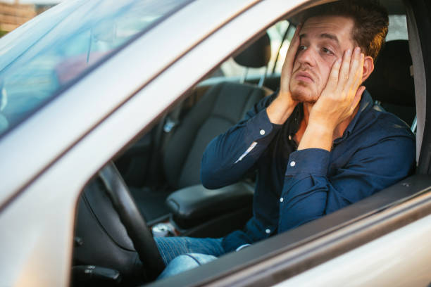 A young man desperately waits in the traffic jam stock photo