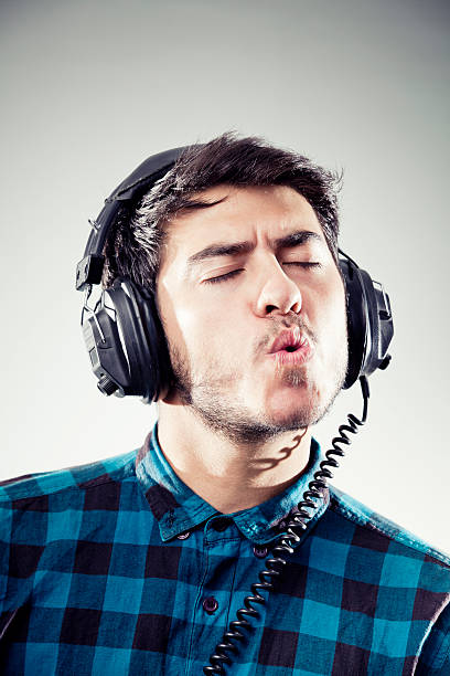Young man enjoying music with eyes closed stock photo