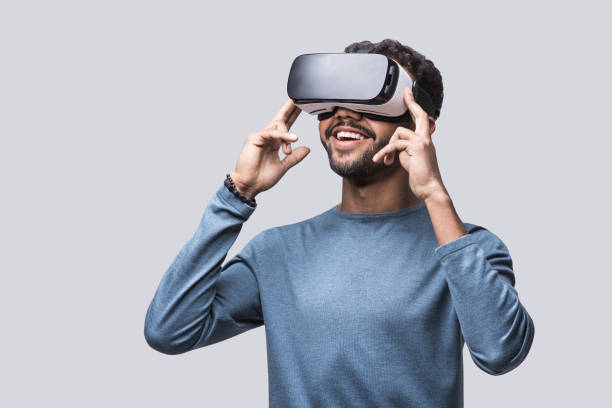 young man experiencing virtual reality eyeglasses headset - vr glasses imagens e fotografias de stock