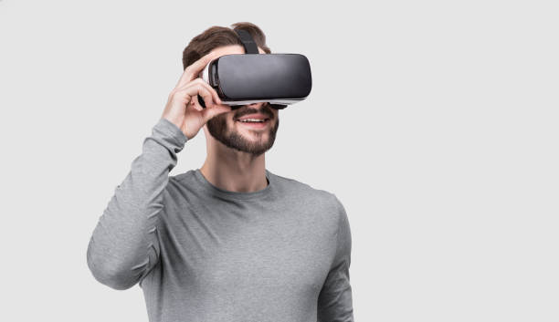 Young man experiencing virtual reality eyeglasses headset stock photo
