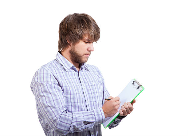 young man filling out a survey stock photo