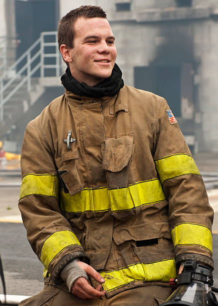 Young man firefighter in uniform stock photo