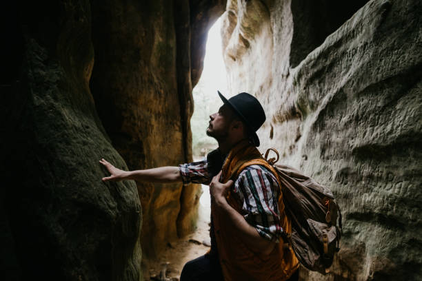 A young man geologist explores a mountain cave, travel concept A young man geologist explores a mountain cave, travel concept geologist stock pictures, royalty-free photos & images