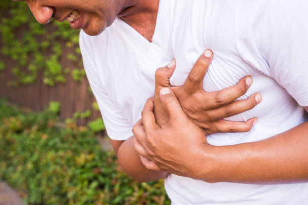 Young man having heart attack stock photo