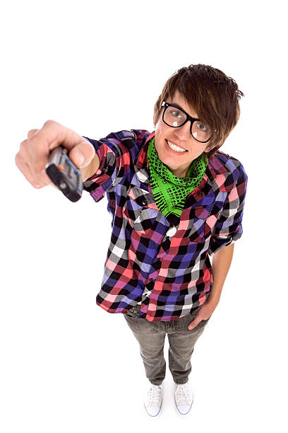 young man holding remote control - man,standing, elevated view,remote control stockfoto's en -beelden