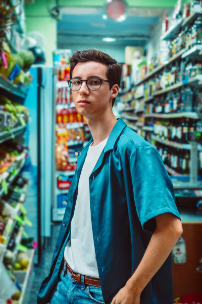Young man in a supermarket stock photo