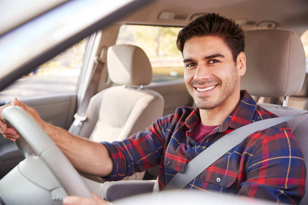 jonge man in auto rijden stoel kijken naar camera, portret - man with car stockfoto's en -beelden