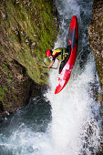 Elevated view of young man kayaking on a waterfall.