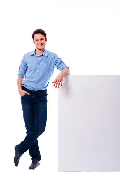 Young man leaning on the empty board  leaning stock pictures, royalty-free photos & images