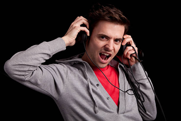 Young man listening to music stock photo