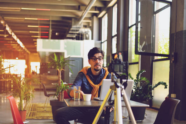 Young man making a video blog stock photo