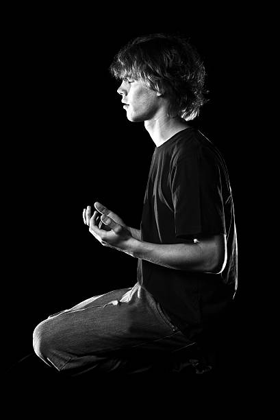 Young man meditating stock photo