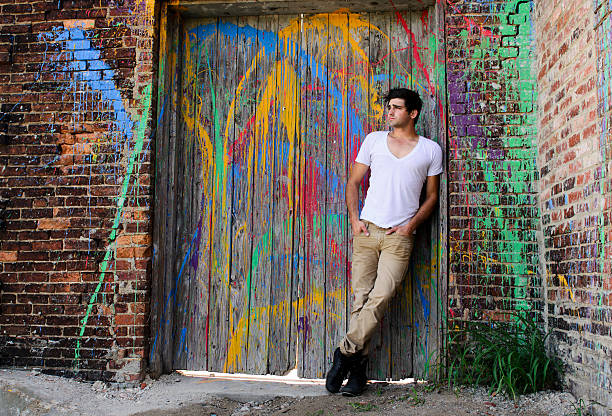 Young Man on Paint-Splattered Door stock photo