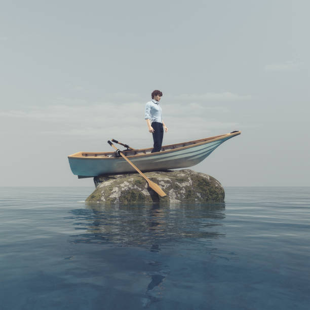Young man Young man standing in a boat blocked on a stone in the middle of the ocean. This is a 3d render illustration boat runs aground stock pictures, royalty-free photos & images