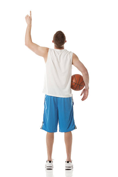 young man posing a rear view holding basketball - basketball player back stockfoto's en -beelden