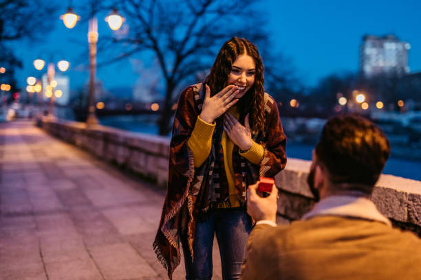 Young man proposing to his girlfriend Young Caucasian man proposing to his beautiful girlfriend. fiancé stock pictures, royalty-free photos & images